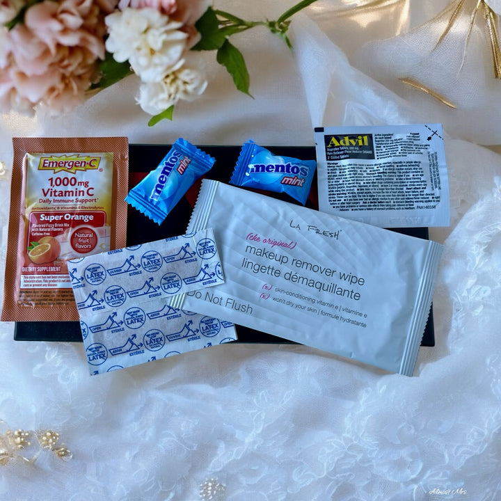 Option A: a soothing makeup wipe, Handy adhesive bandages (x2), Refreshing Mentos mints (x2),Immune-boosting Emergen-C Vitamin C powder packet, and Pain-relieving Advil packet